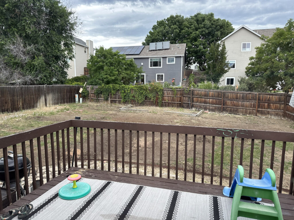 The backyard of our abandoned home with lots of dirt