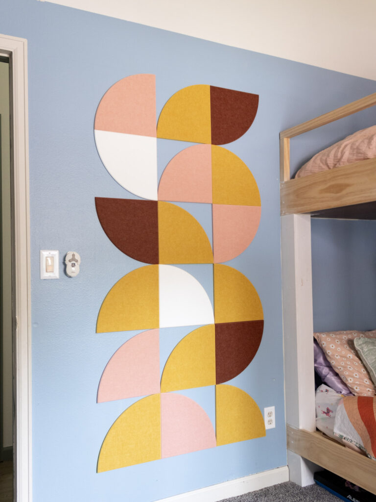 The Nectar FeltRight Tiles design on a blue wall in a kids' bedroom