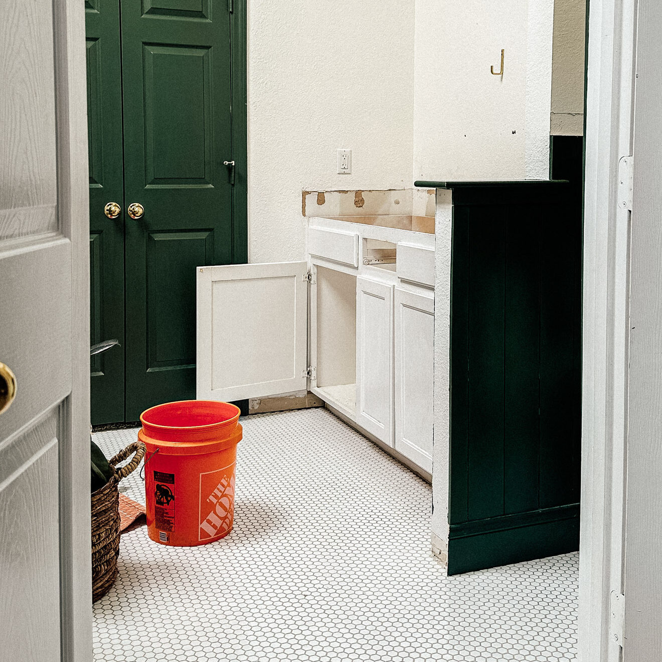 white bathroom cabinet with the countertop and sinks removed