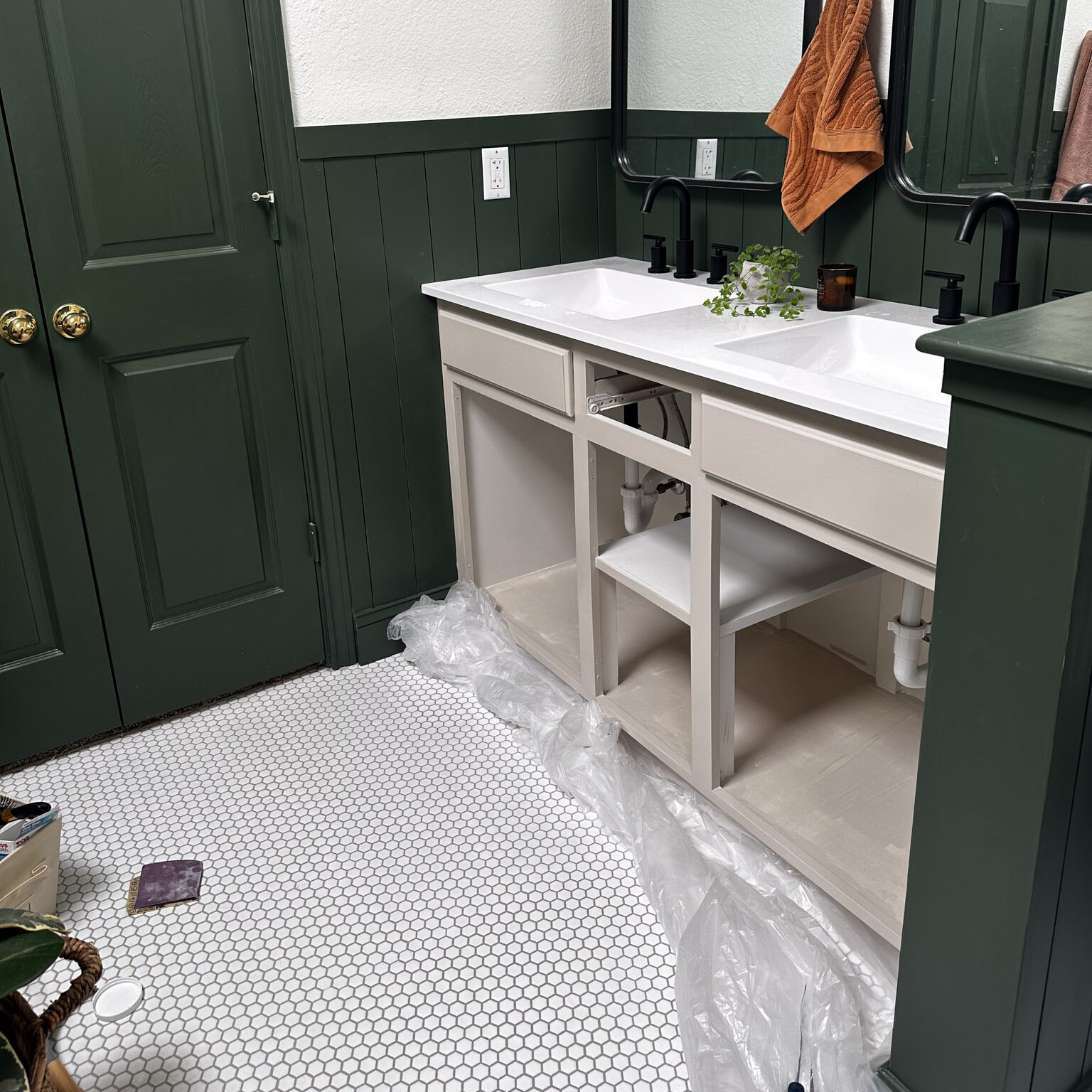 Warm gray bathroom cabinet in the process of being painted. 