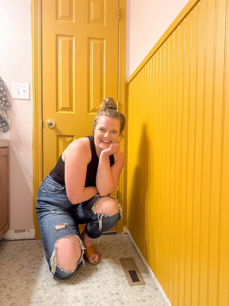 mustard yellow trimmed pink small bathroom with a green penny tile floor