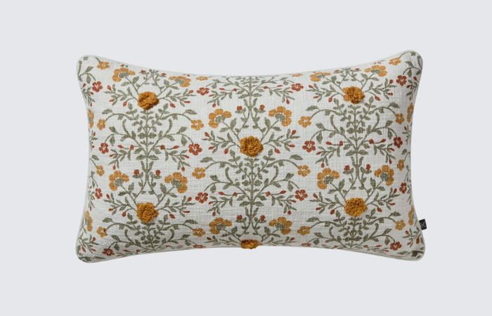 tan rectangle throw pillow with orange, green, and mustard yellow florals