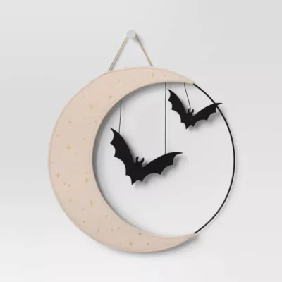 wood circle wreath that looks like a half-moon with two black hanging bats inside the wreath