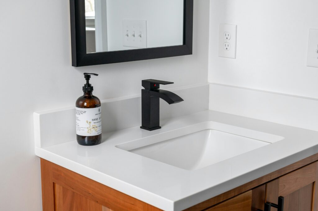 White bathroom sink with a blank faucet.