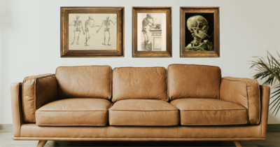 leather couch with three skeleton vintage prints in gold frames