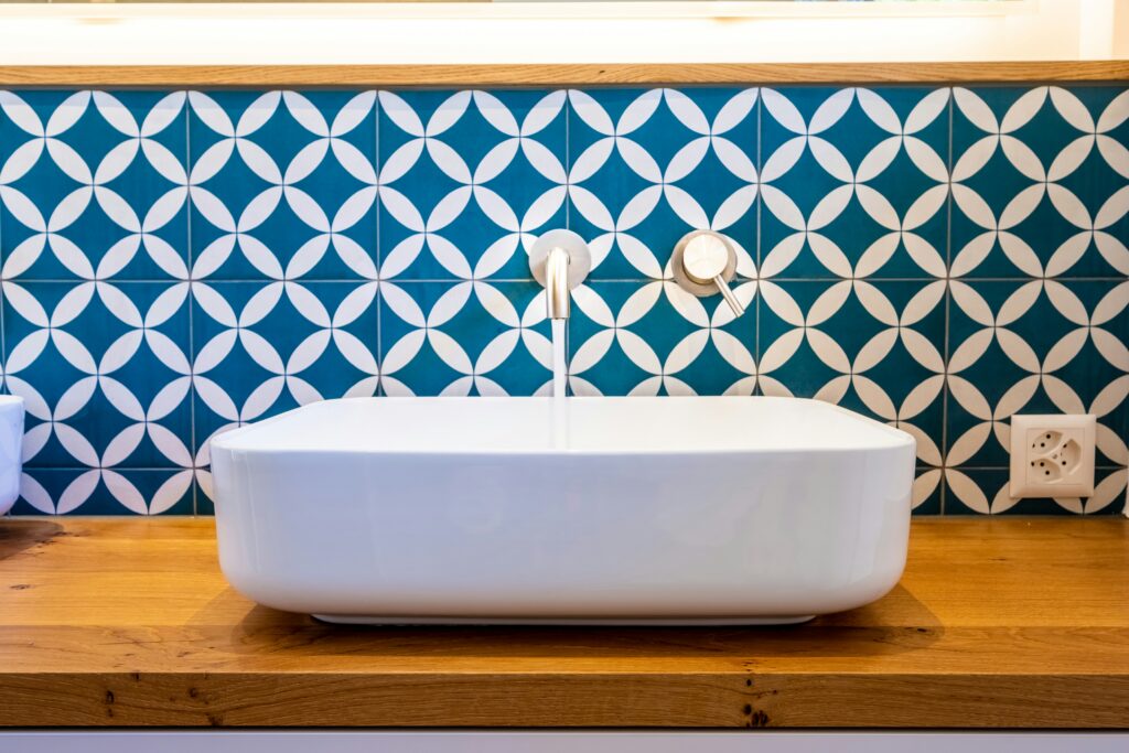 Blue and white checked backsplash with a white sink