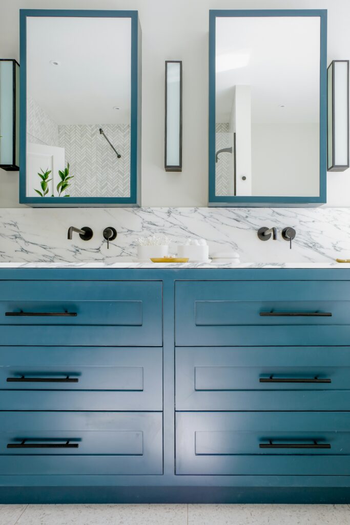 blue bathroom vanity with black cabinet handles