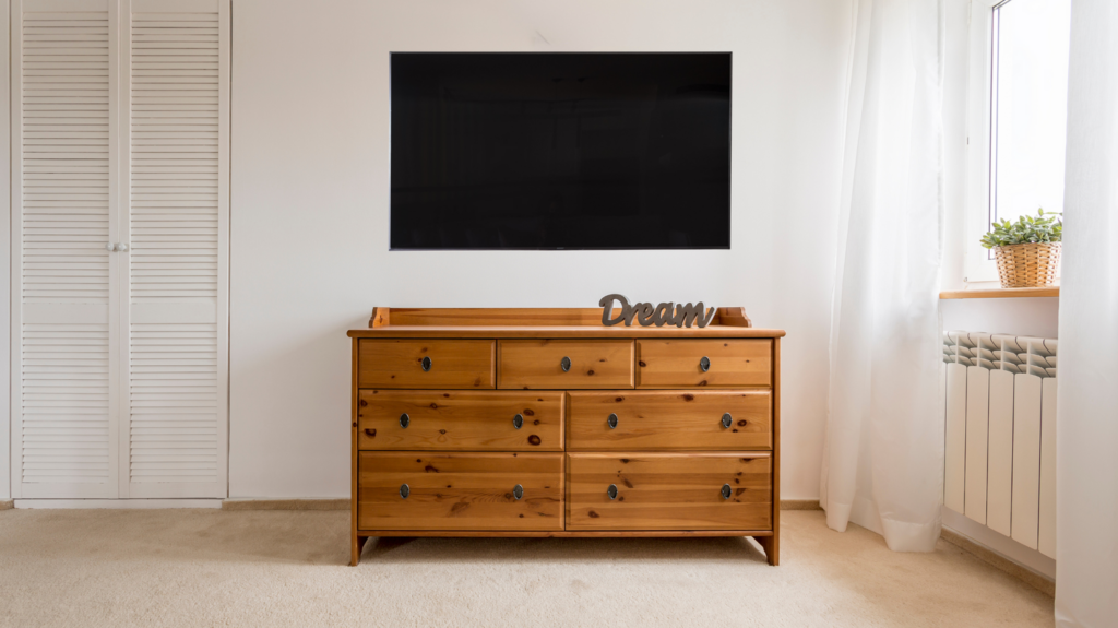 multipurpose tv stand dresser under a tv in a living room design